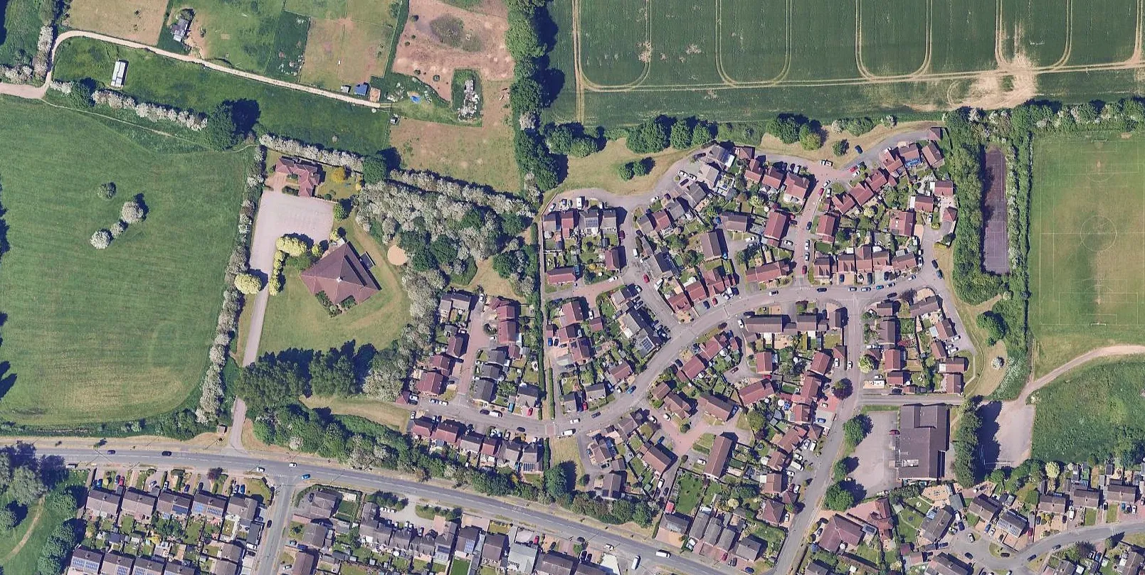 Aerial view of an English residential estate bordered by fields